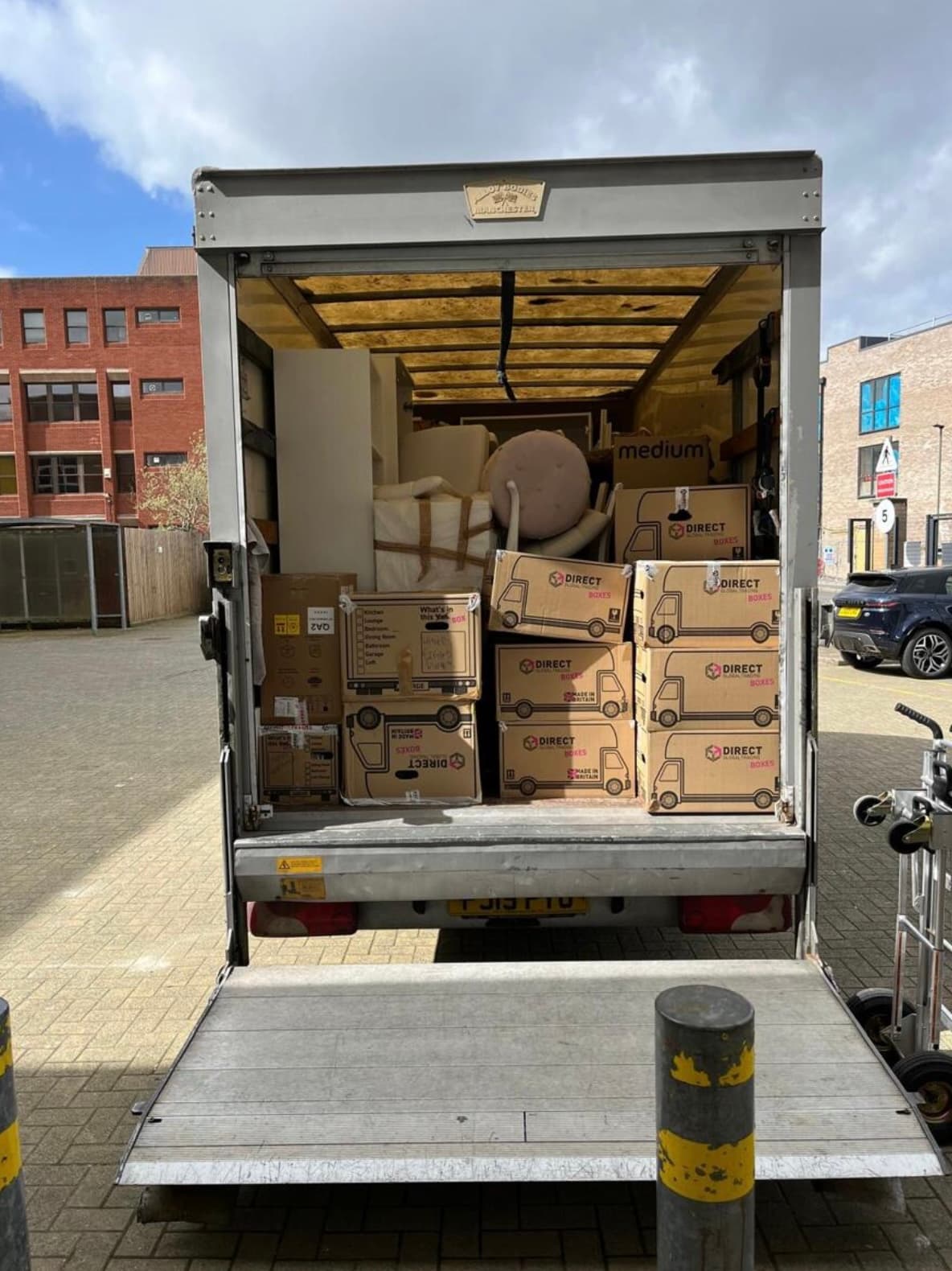 Luton van fully loaded with moving boxes — city delivery